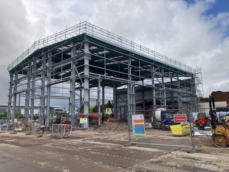 An exterior of a large building framework under construction.